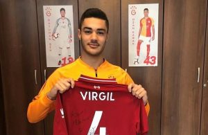 Ozan Kabak receives a signed Virgil van Dijk shirt from the Liverpool star